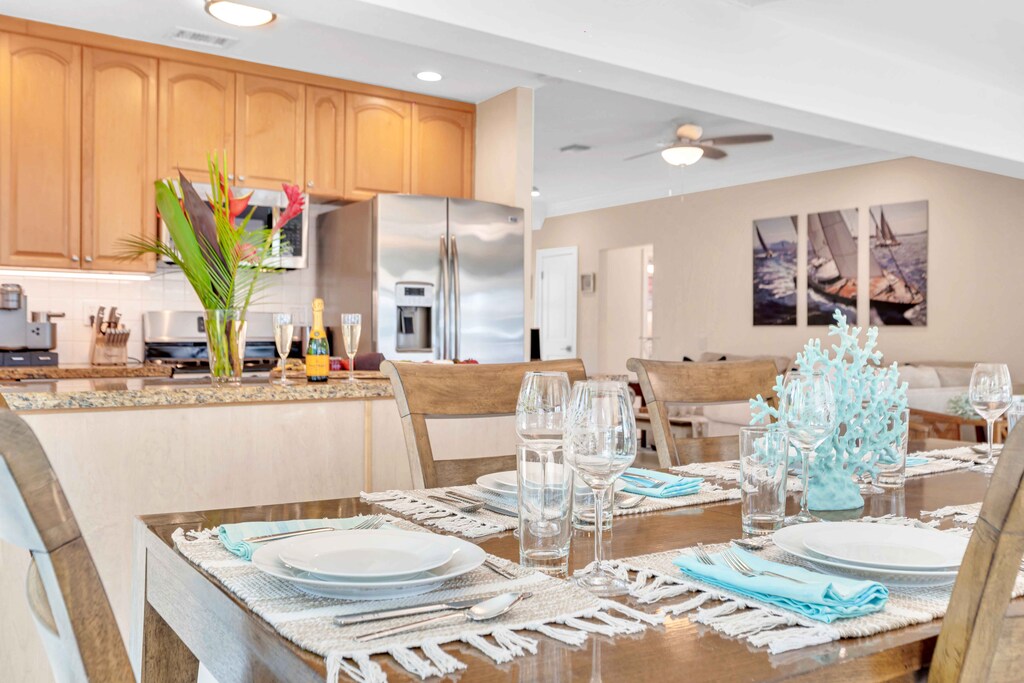 The kitchen / indoor dining room has a view of the pool and the waterfront.