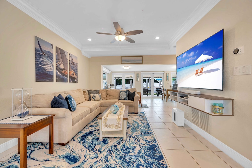 The living room offers a view of the waterfront and also includes a pullout couch and a 65in Smart TV.