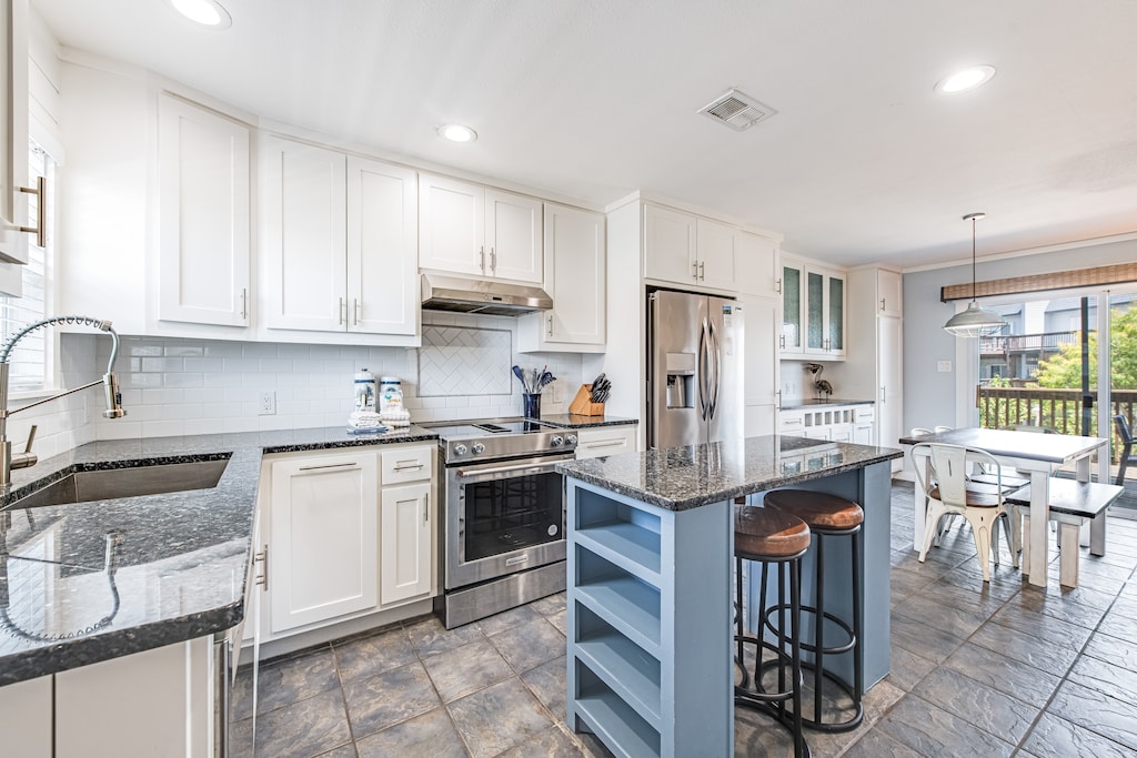 interior. Kitchen and island with seating for two and dining table seating for six