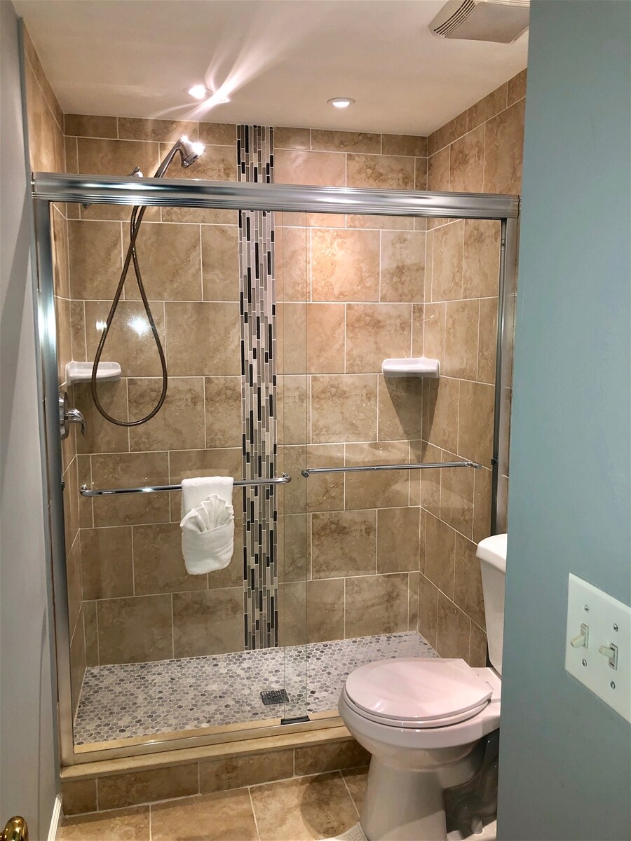 Second floor, hallway full-bathroom, features a frameless shower -added range of motion-