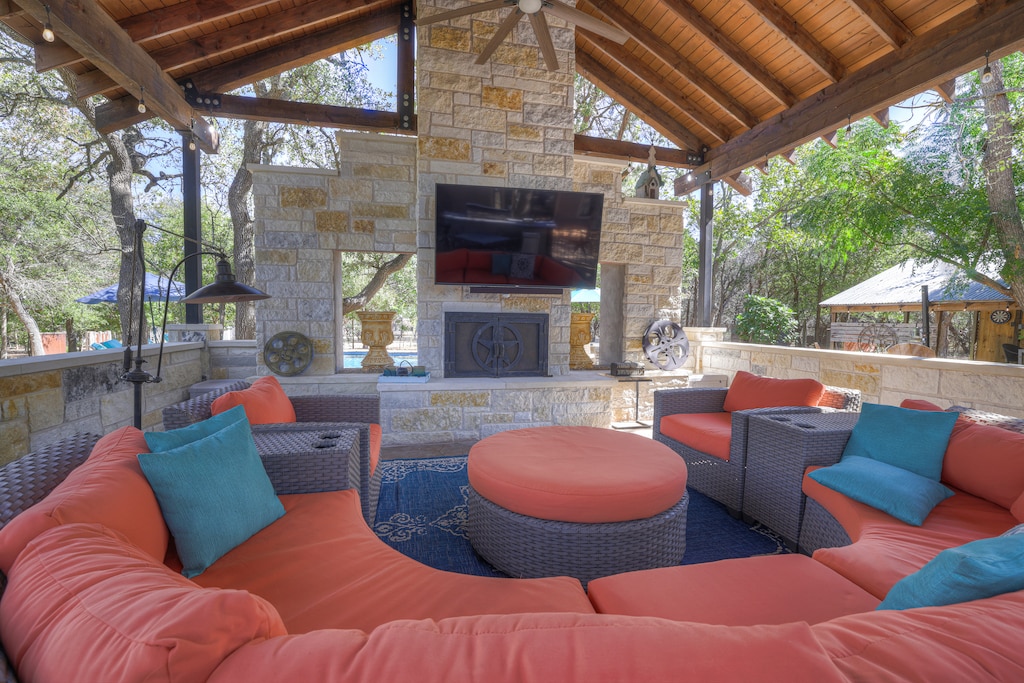 Take a break in the shade on the spacious outdoor patio with a large half-circle couch to enjoy a weekend game with the whole family.
