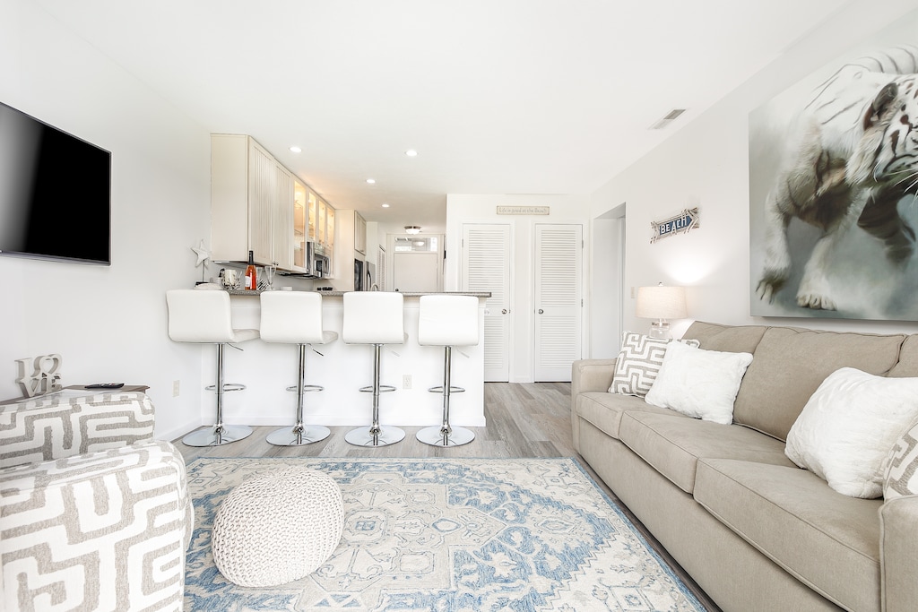 Observing the unit, you'll find a sofa, a charming breakfast nook, and a well-appointed living room.