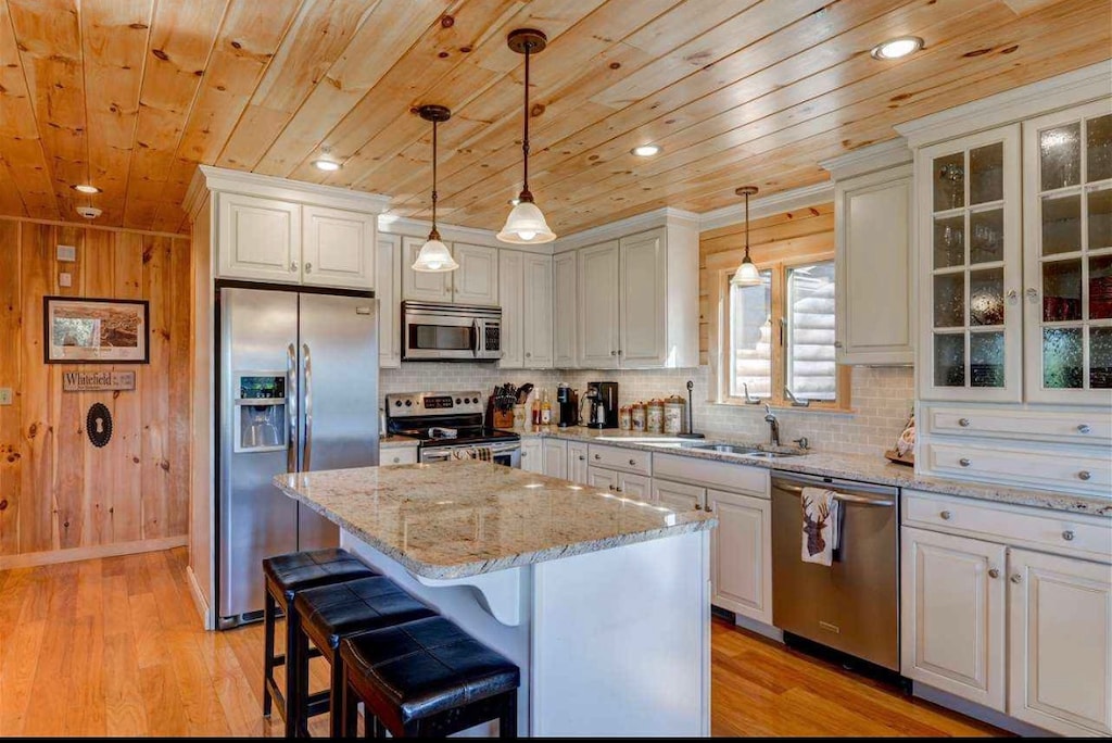 The beautiful kitchen with granite countertops, high-end stainless steel appliances, and a cozy breakfast bar that seats 3.