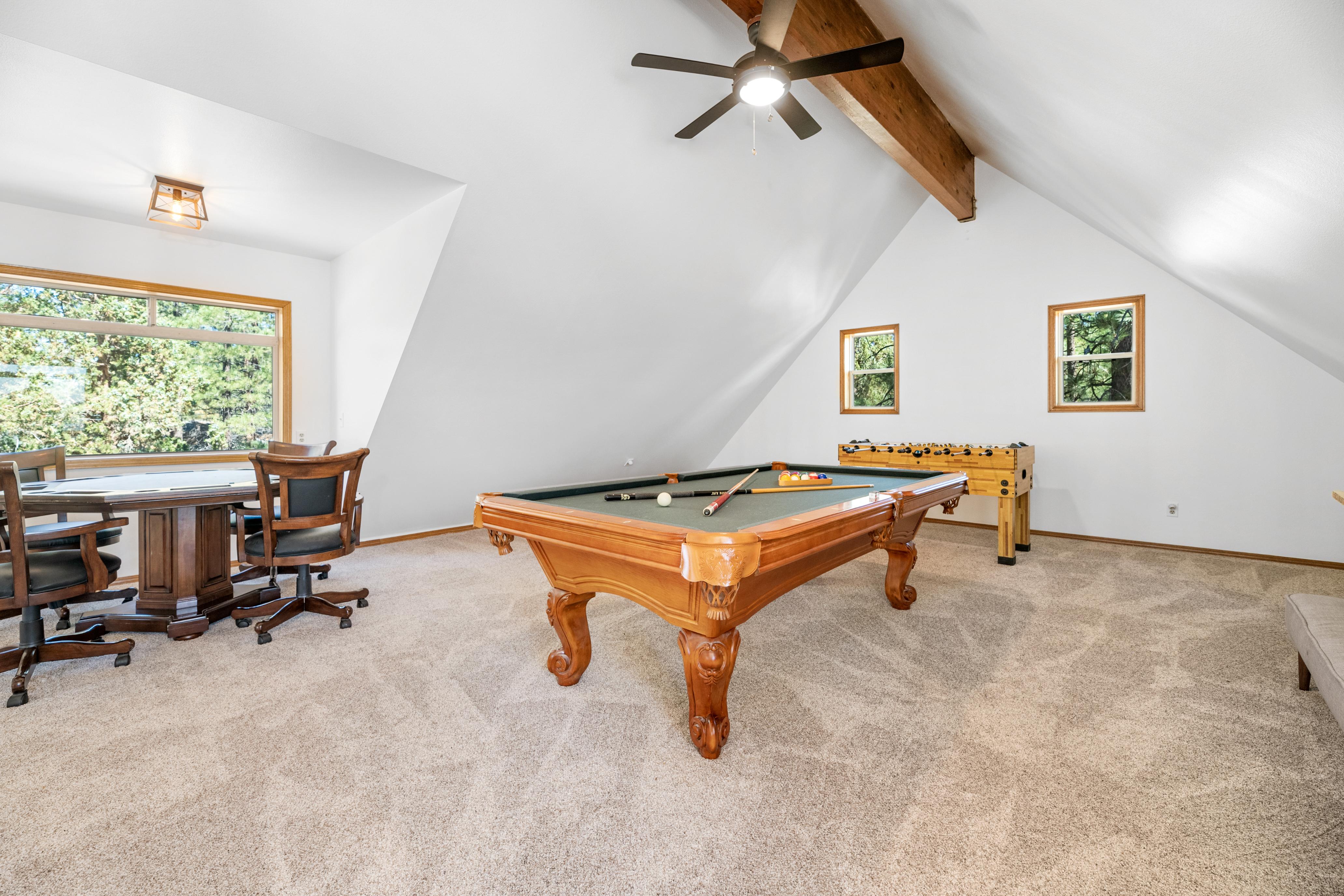 Third story loft Game Room with Pool Table, Foosball, Poker/Game Table, Bar, 65-inch 4k Smart TV, Fireplace and access to an elevated deck with picturesque views of the lake and slopes.  
