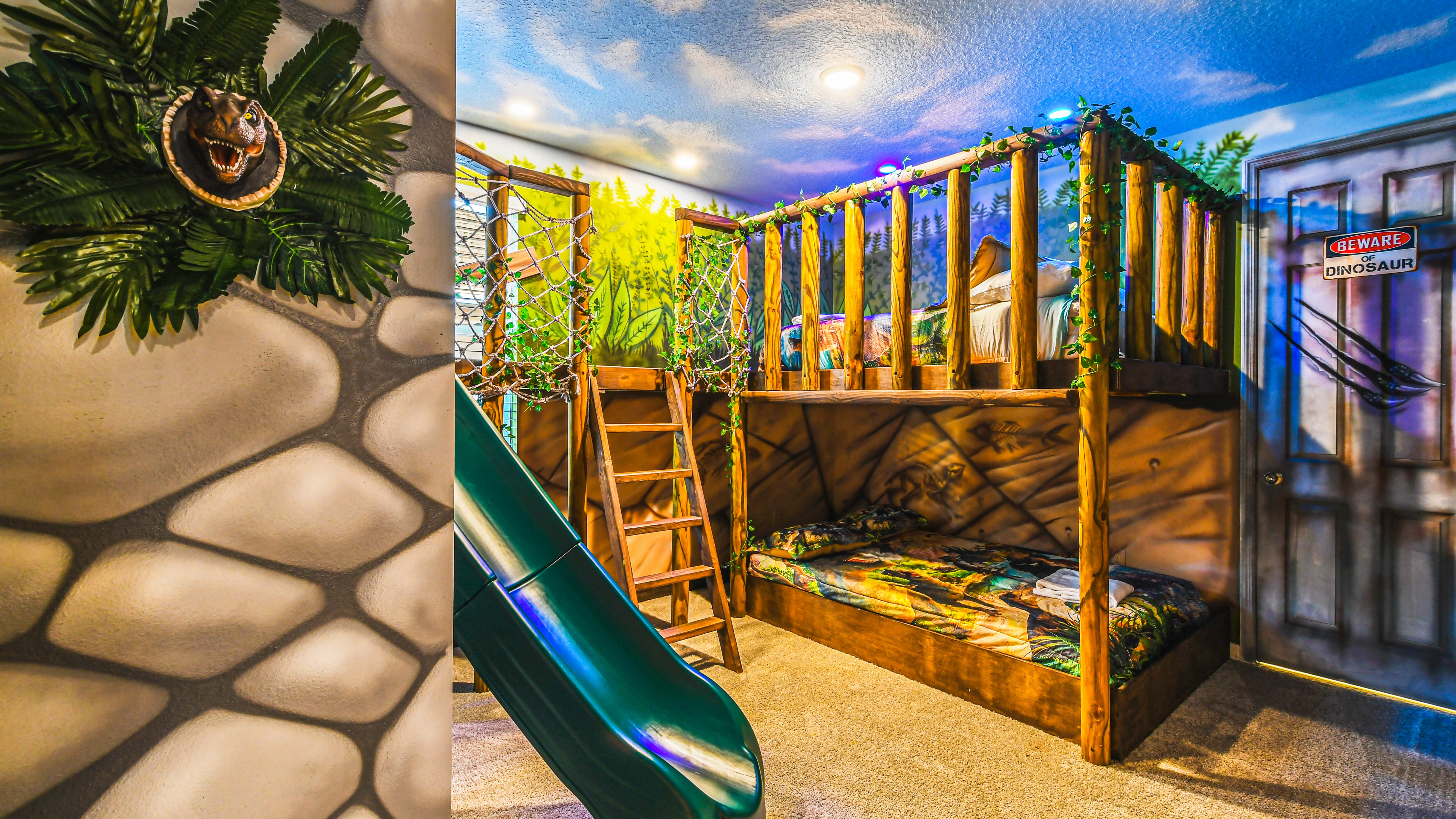 Kids will love the upstairs bedroom with a cool Jurassic theme