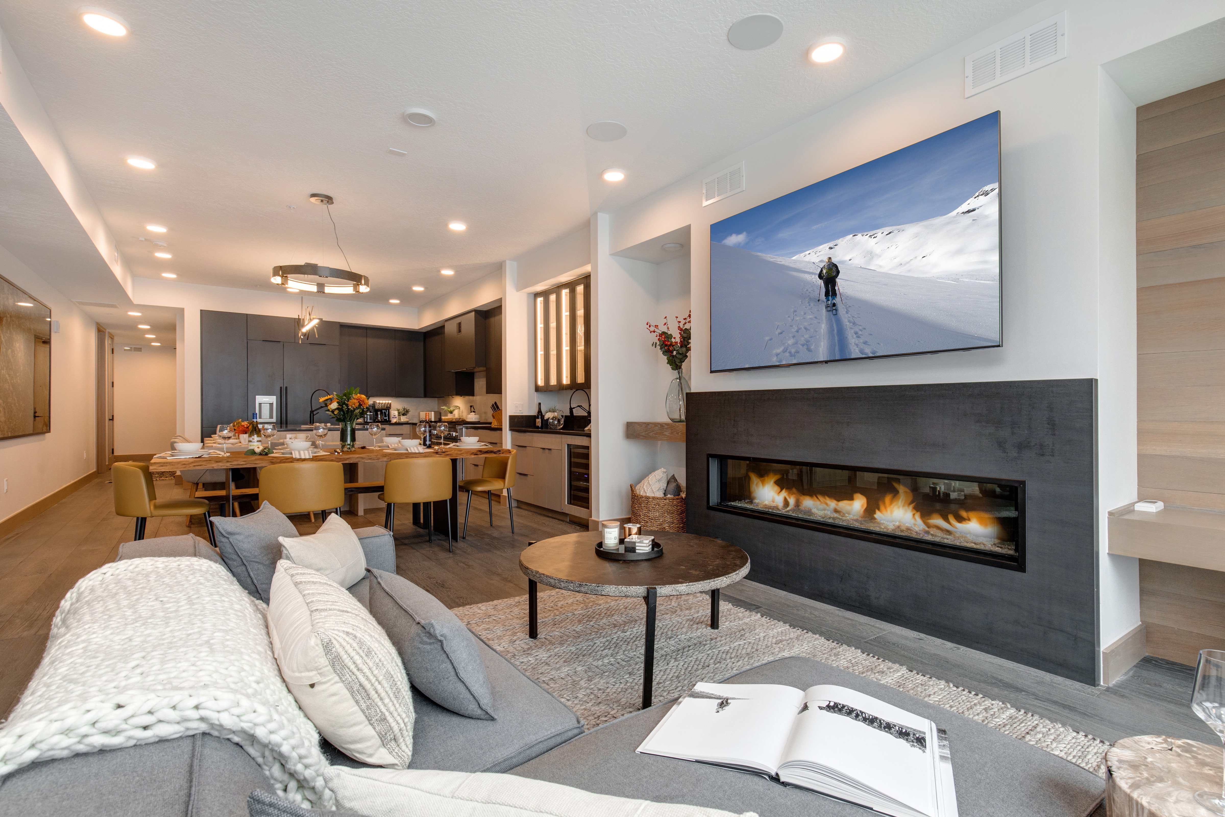 Living Room with sectional, Smart TV, gas fireplace, and private balcony access