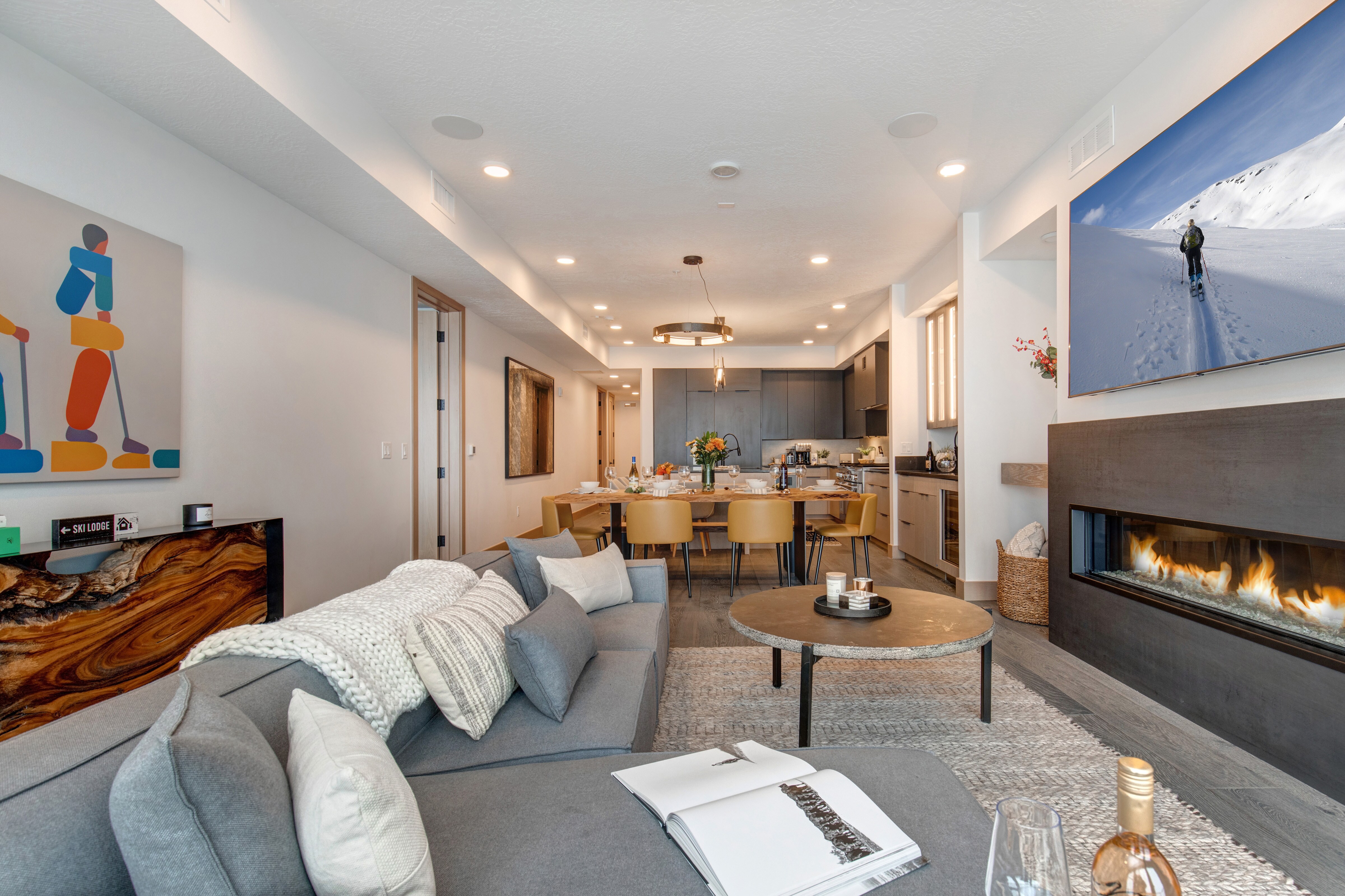 Living Room with sectional, Smart TV, gas fireplace, and private balcony access