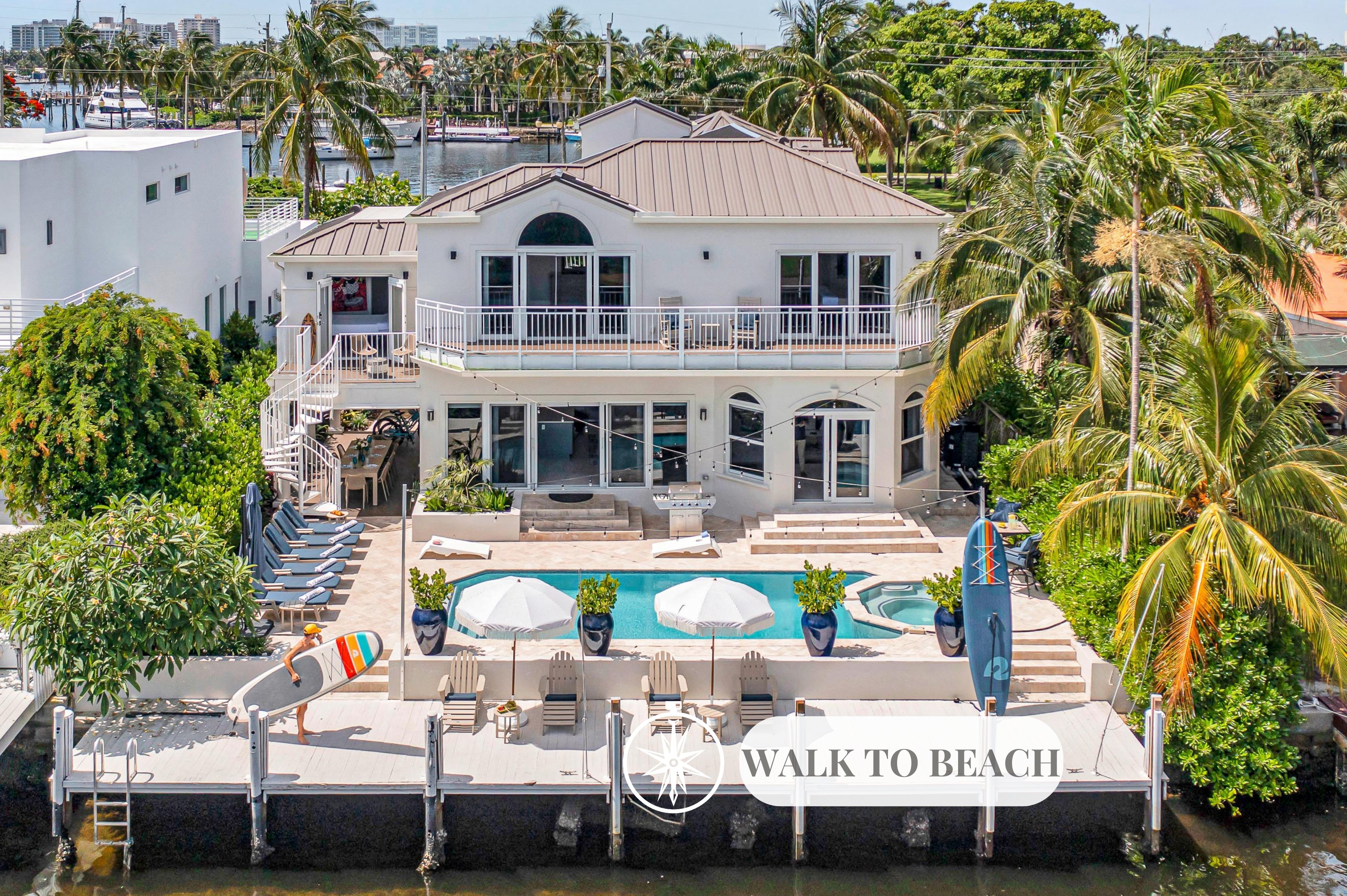 This modern coastal open floor plan villa offers waterfront views and access a short walk from the beach.