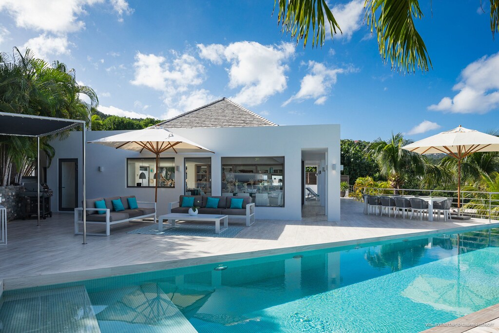 Large heated pool on the main level, smaller heated pool on the lower level, ideal for kids. Large teak terrace, with deckchairs. Outdoor dining and lounge areas. Gas barbecue. 