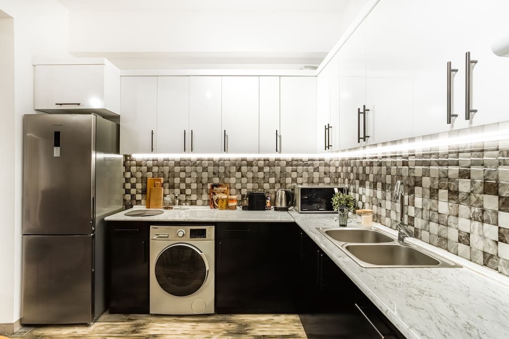 Fully equipped kitchen with the fridge and washing machine