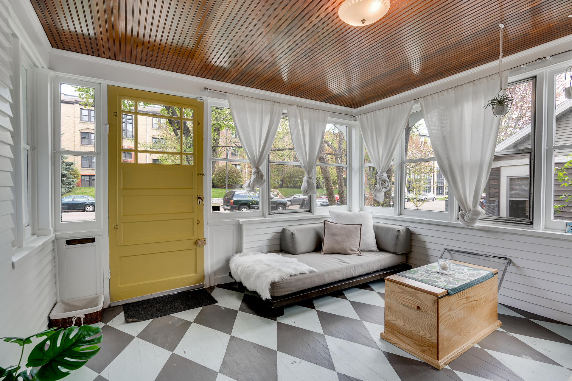 Adjacent the living room, the three-season porch beckons...