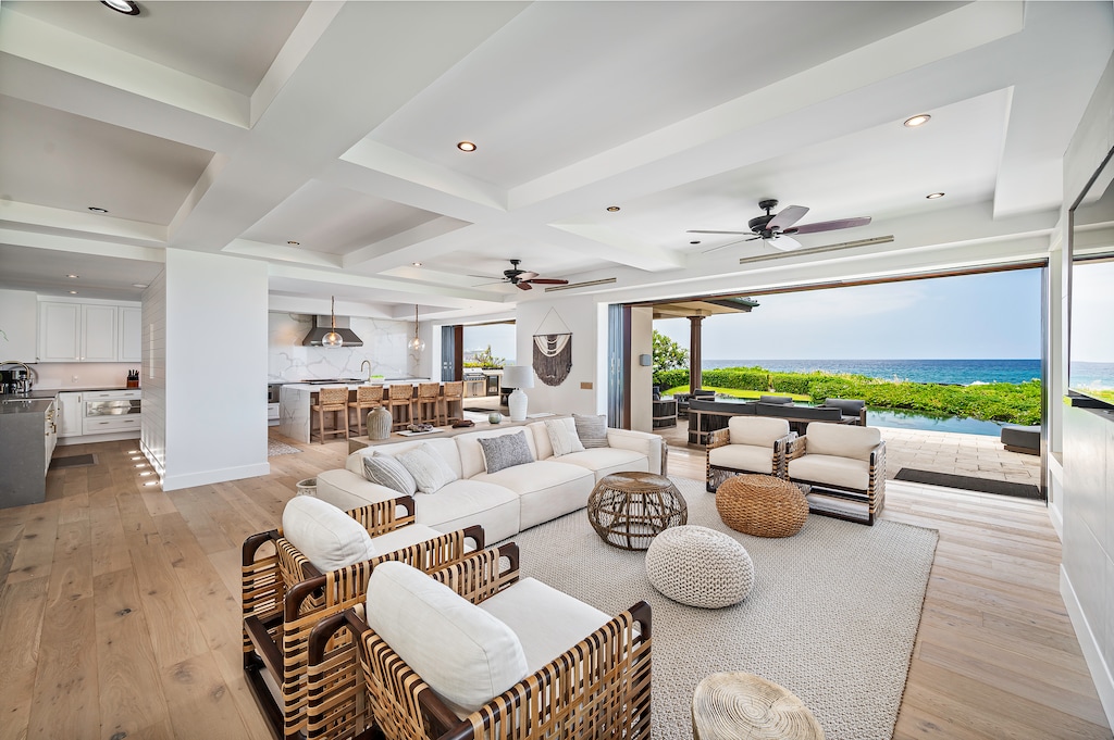 Open concept living room with built in 80 inch TV, Restoration Hardware furniture from their Luxury Beach Edition