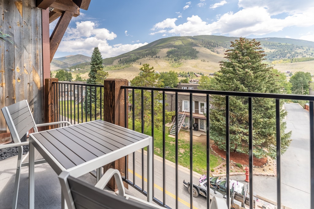 Private balcony featuring outdoor seating and incredible alpine views. 