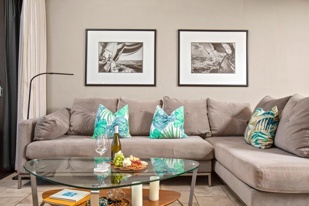 Sip and snack in style on this plush sectional, framed by striking monochrome art and glowing natural light