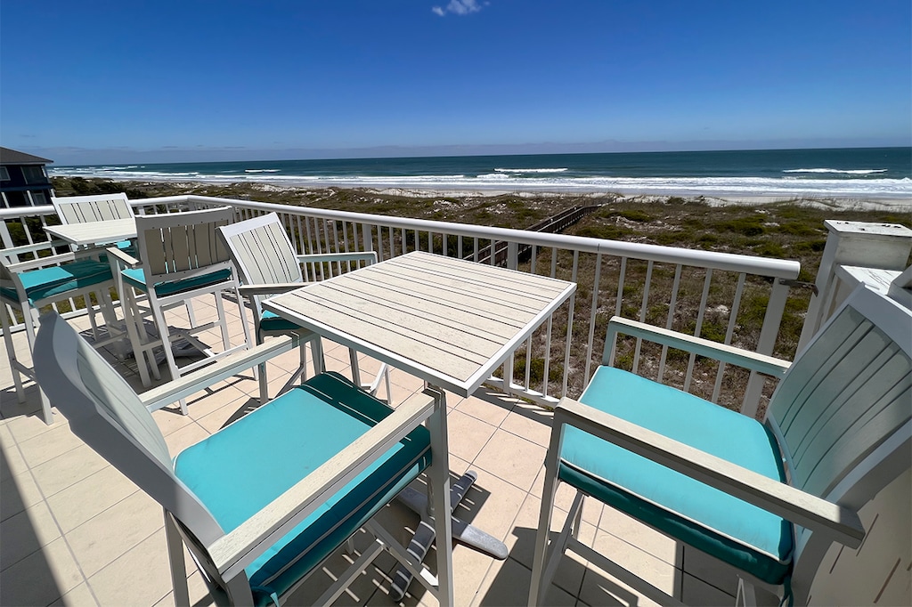 Inviting and spacious porch with comfortable seating, ideal for relaxing or dining outdoors