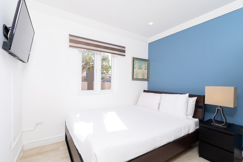 Bedroom 3 with a Queen size bed and cozy ambiance, blending comfort and aesthetics