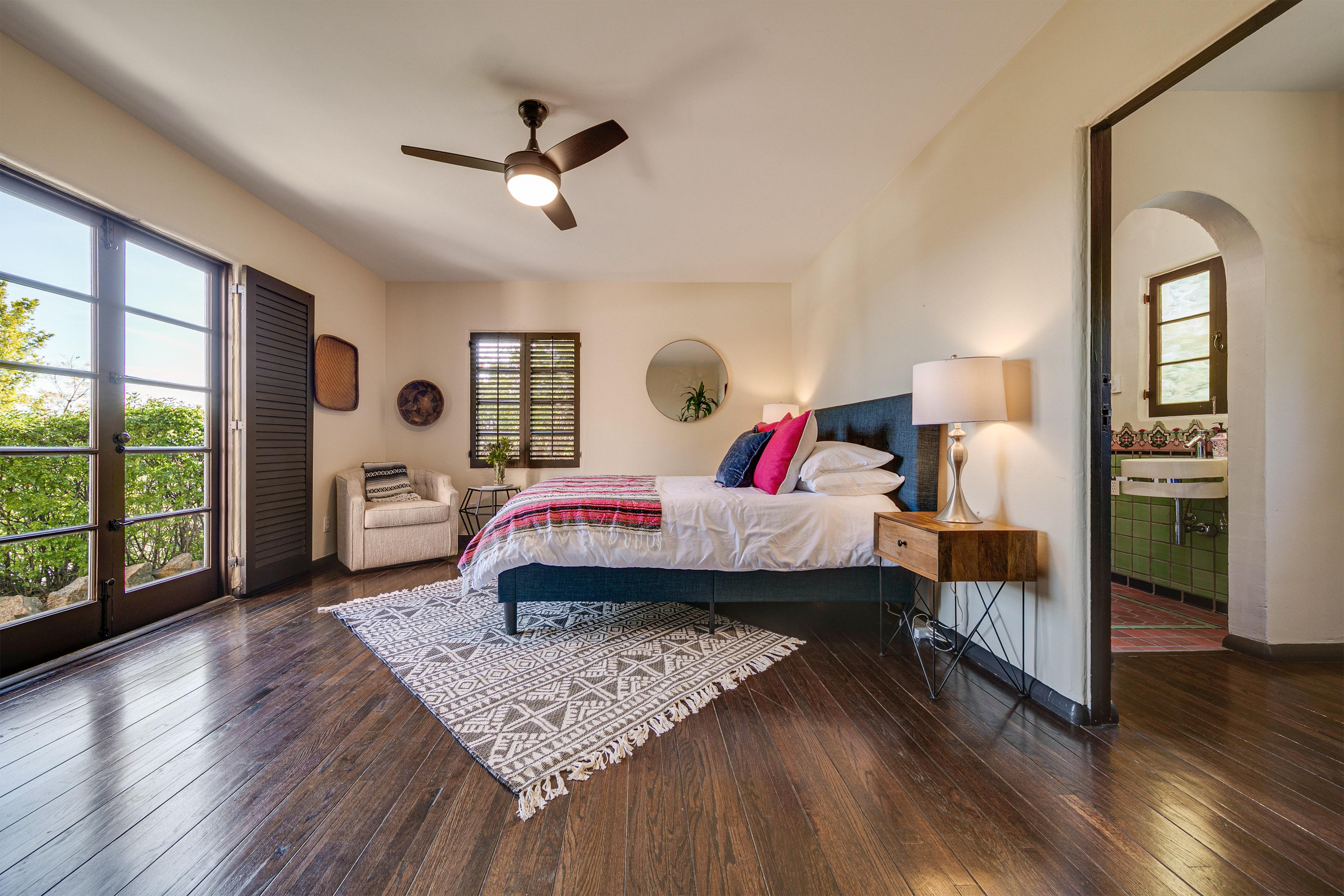 The first floor bedroom boasts a queen bed, with a large walk in closet area, built ins within that closet and a full bathroom