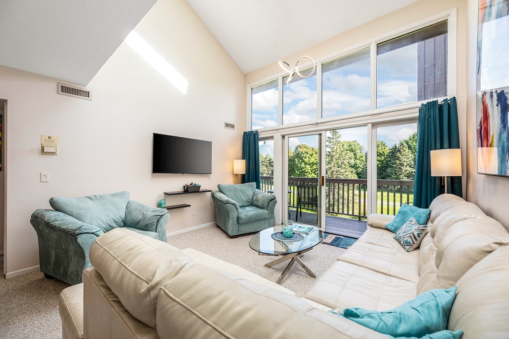 Elevate your Northern Michigan escape with sweeping golf course views, spa-inspired suites, and a dramatic two-story wall of windows