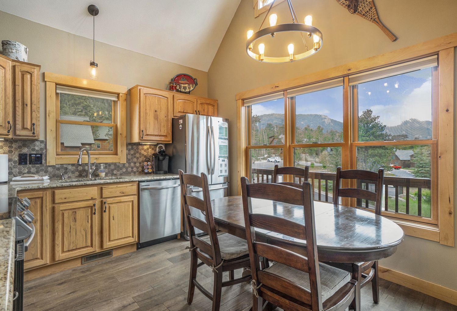 Solitude Eagle 5 - Kitchen with oval dining table with seating for 4, refrigerator, dishwasher, sink, and windows with mountain views.