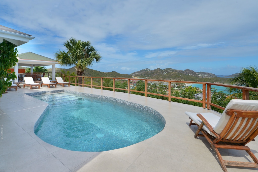 Beautiful pool, nice terrace with lounge area, deck chairs, and panoramic views over the bay. 
