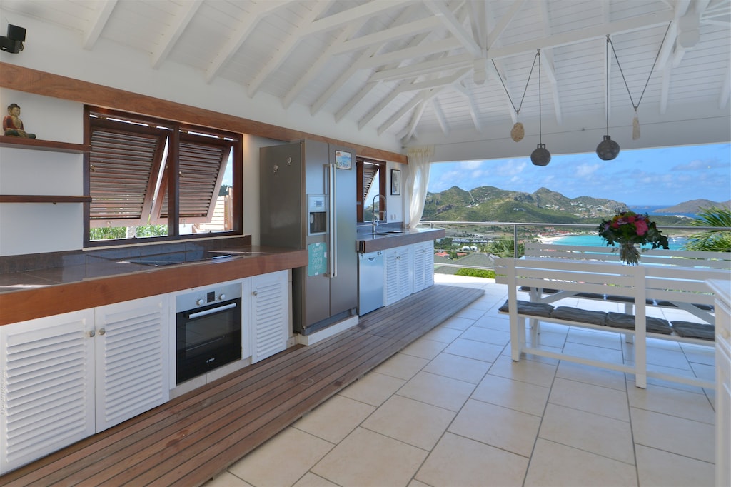 Fully equipped open-air, electric stove and oven, dishwasher, fridge and freezer, coffee and Nespresso machines, microwave, blender, kettle, fruit squeezer. Inside large white wooden table by the kitchen for up to 8 guests. Outside round teak table by the
