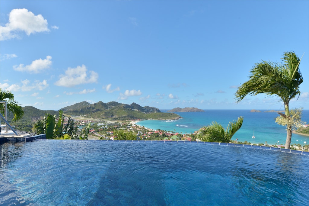 Beautiful pool, nice terrace with lounge area, deck chairs, and panoramic views over the bay. 