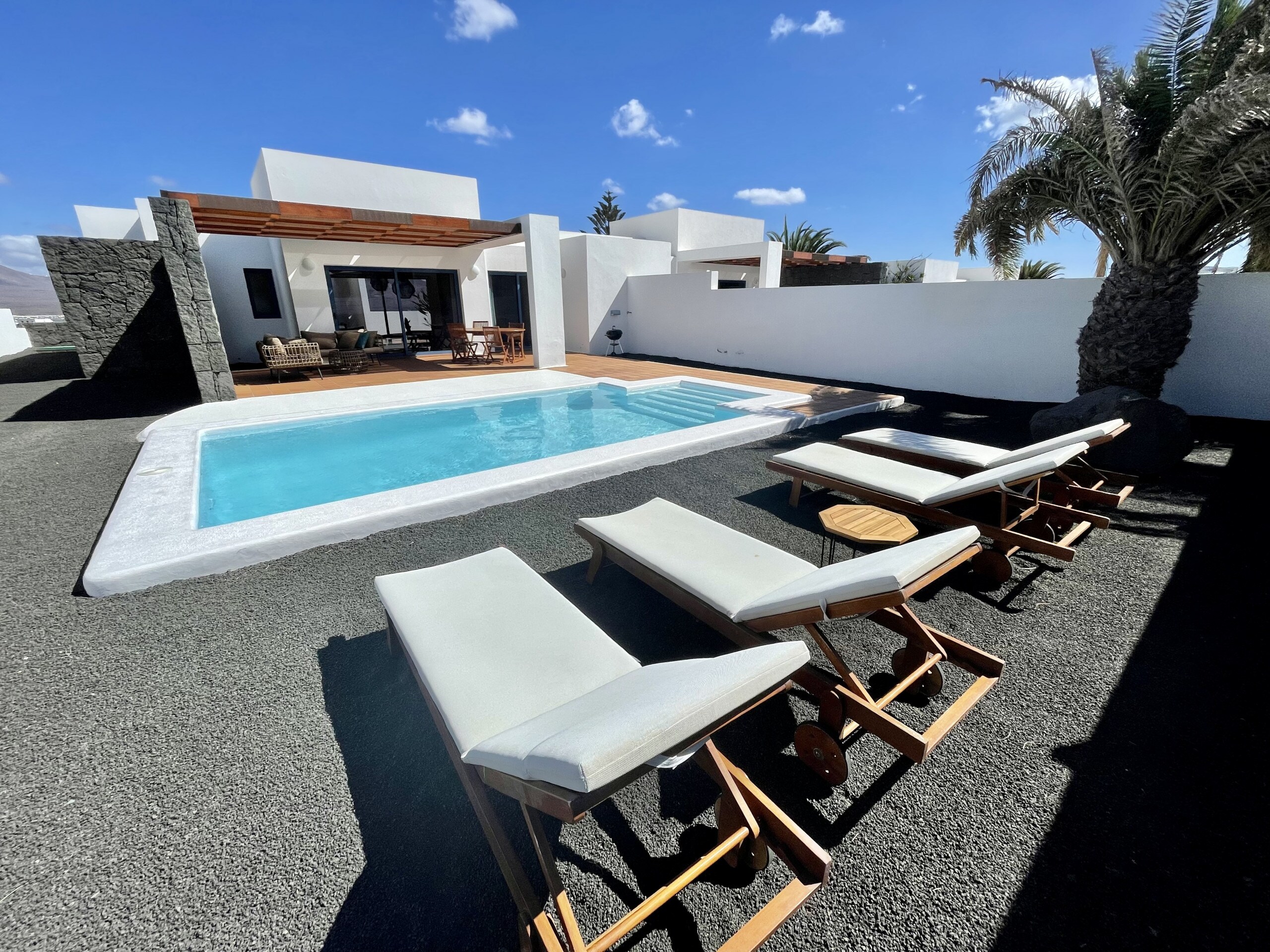 Large terrace with outdoor furniture and private pool heated by a heat pump