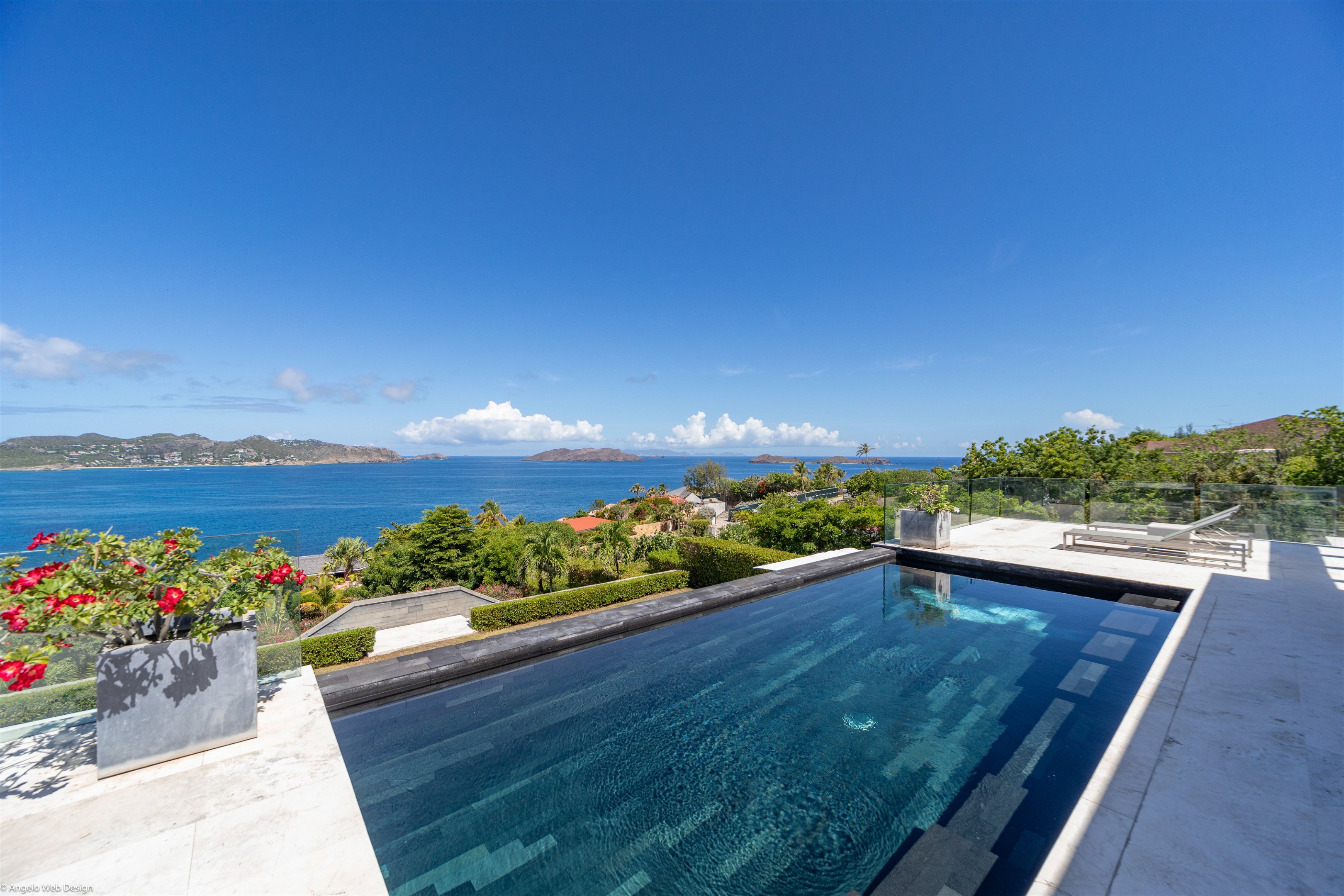 Expansive heated pool on the upper level, smaller heated pool on the lower level. Two-level terrace, with loungers, deck chairs, facing the views. 