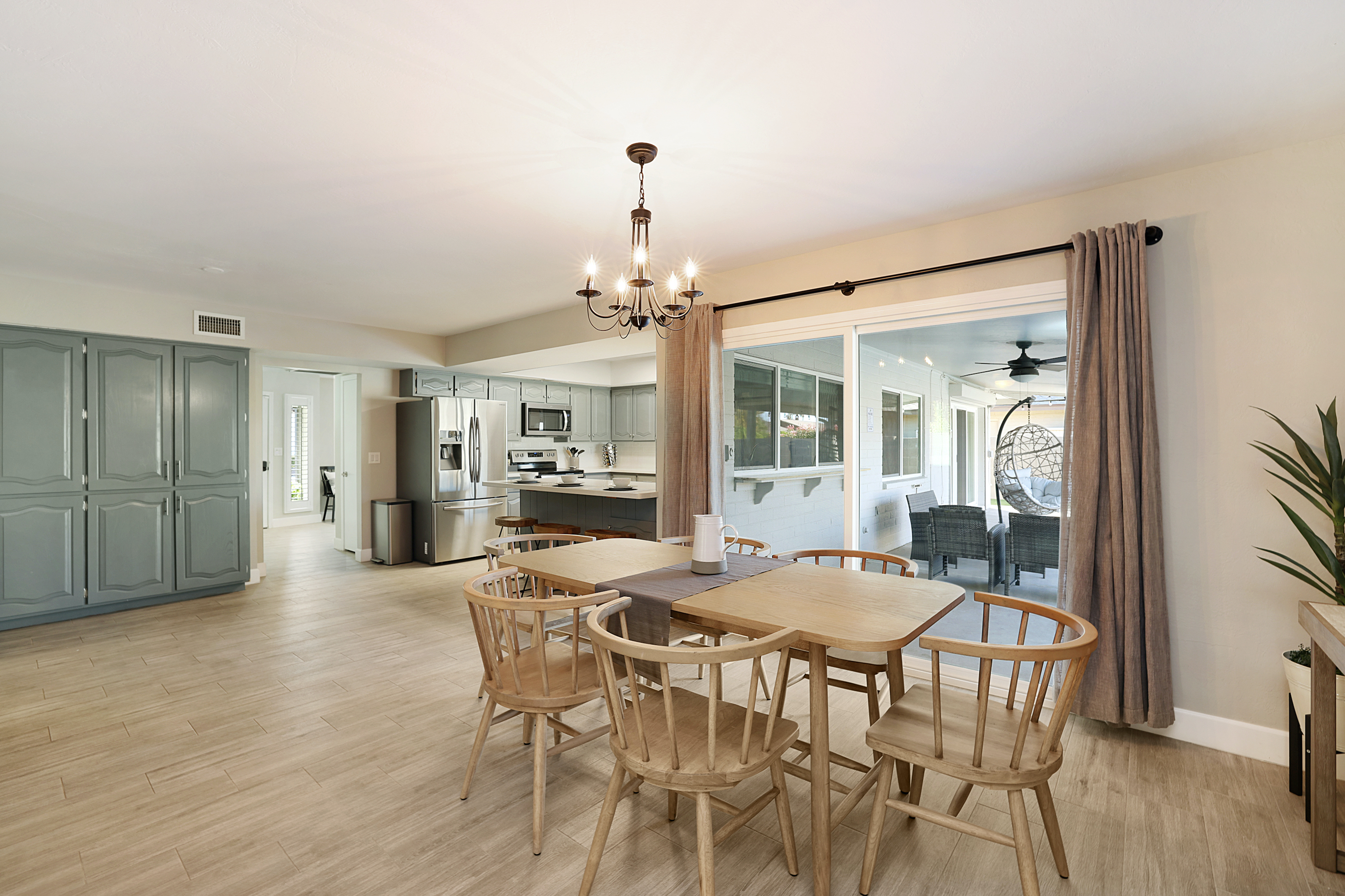 Kitchen table and kitchen island seating available with a sliding door which looks out to the pool.