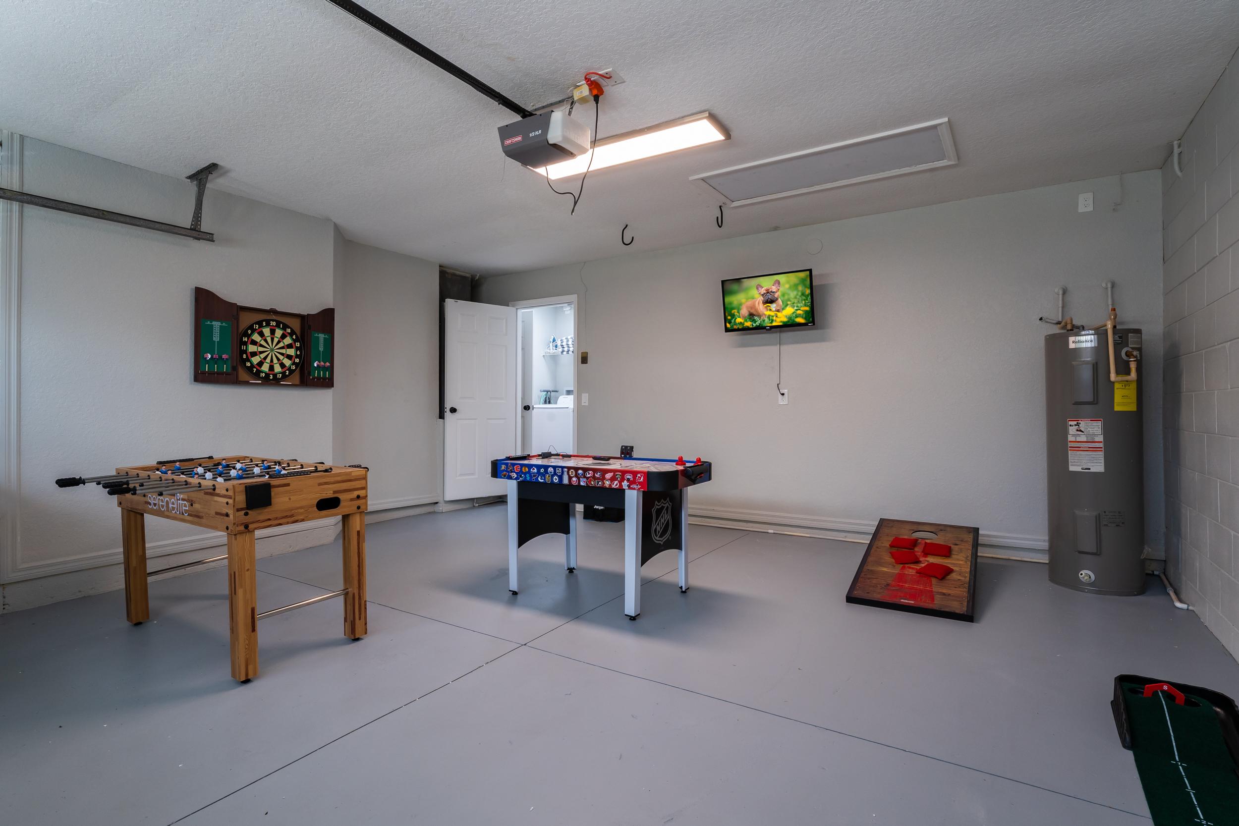 Fun-filled Game Room in Garage with TV, Foosball, Air Hockey, and Various Board Games