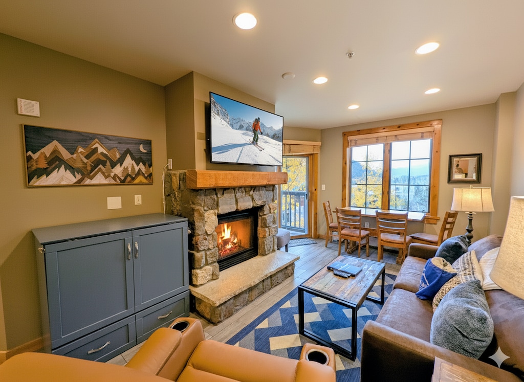 Living room with gas fireplace and large TV