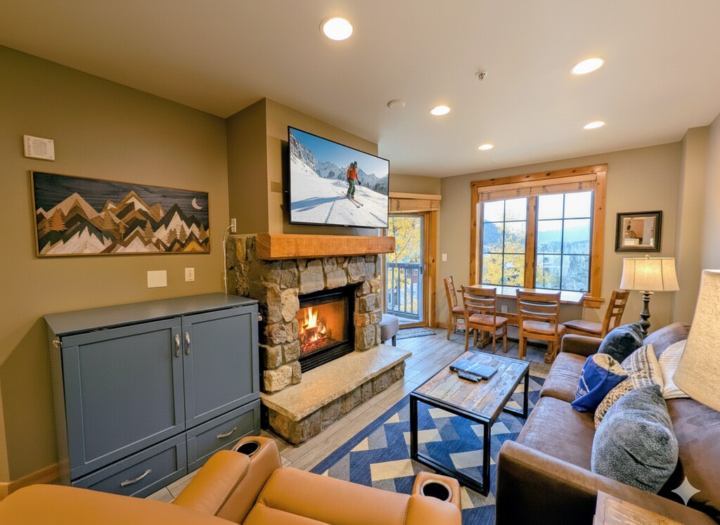 Living room with gas fireplace and large TV