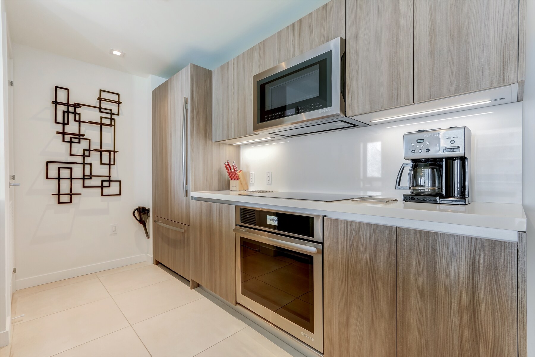 Modern kitchen features a built-in fridge