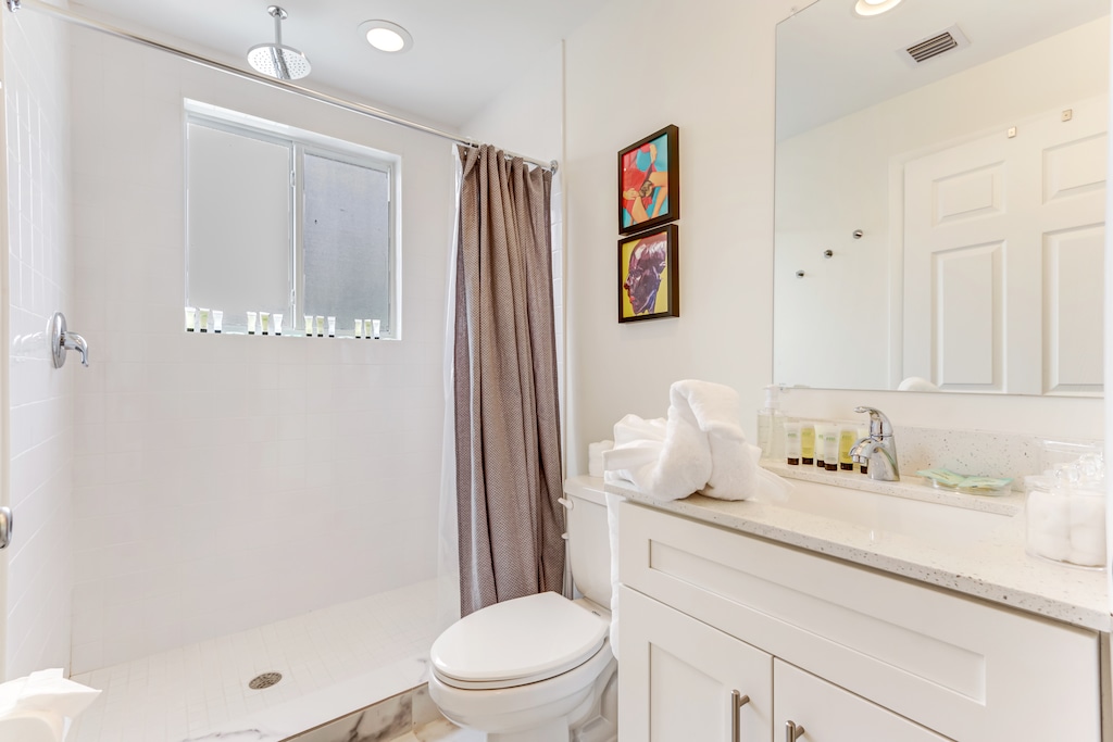 Hallway full-bathroom stocked with necessities