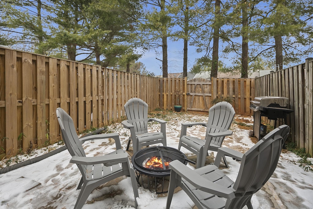 Cozy outdoor space features a fire pit -perfect for S`mores-