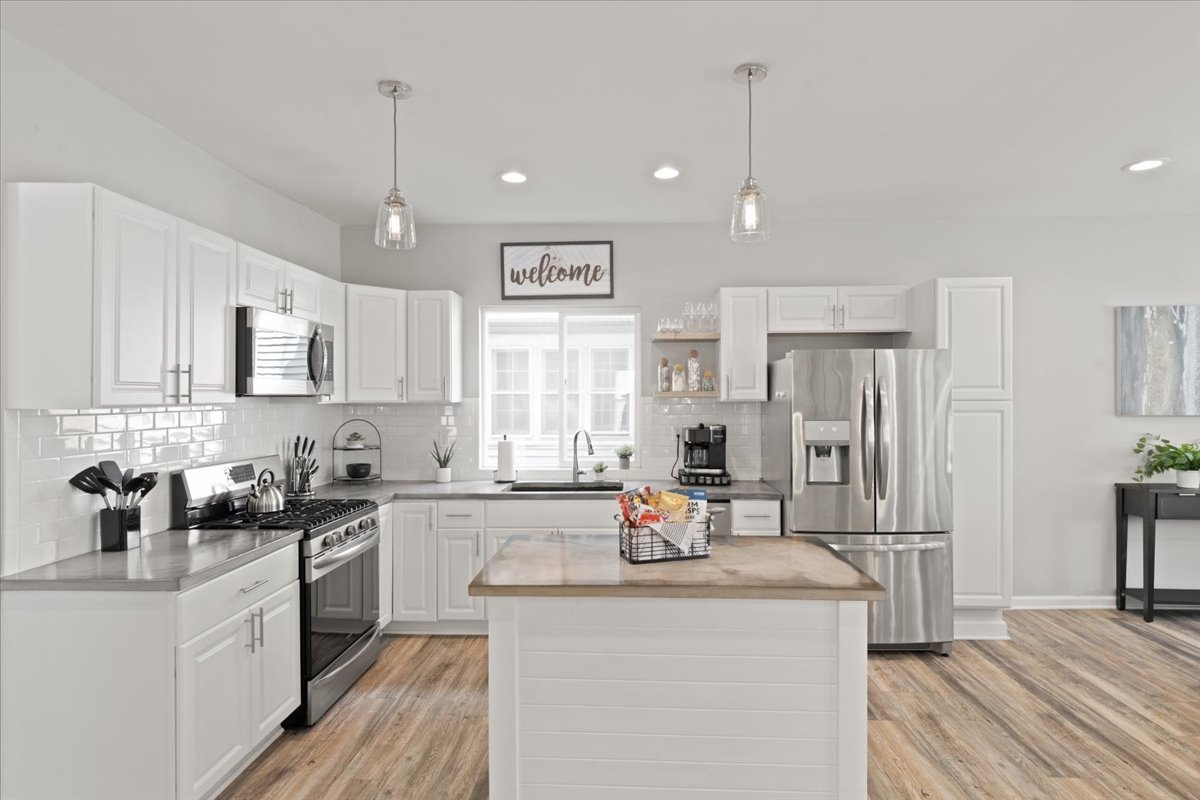 Kitchen | featuring an electric range & dishwasher