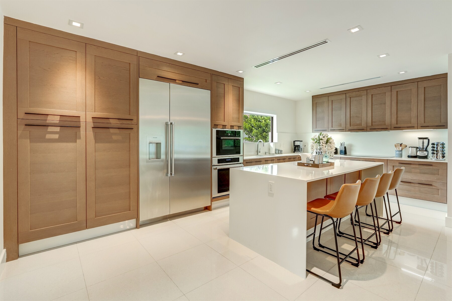 Grand kitchen renders an oversized fridge -simplifies family gatherings-