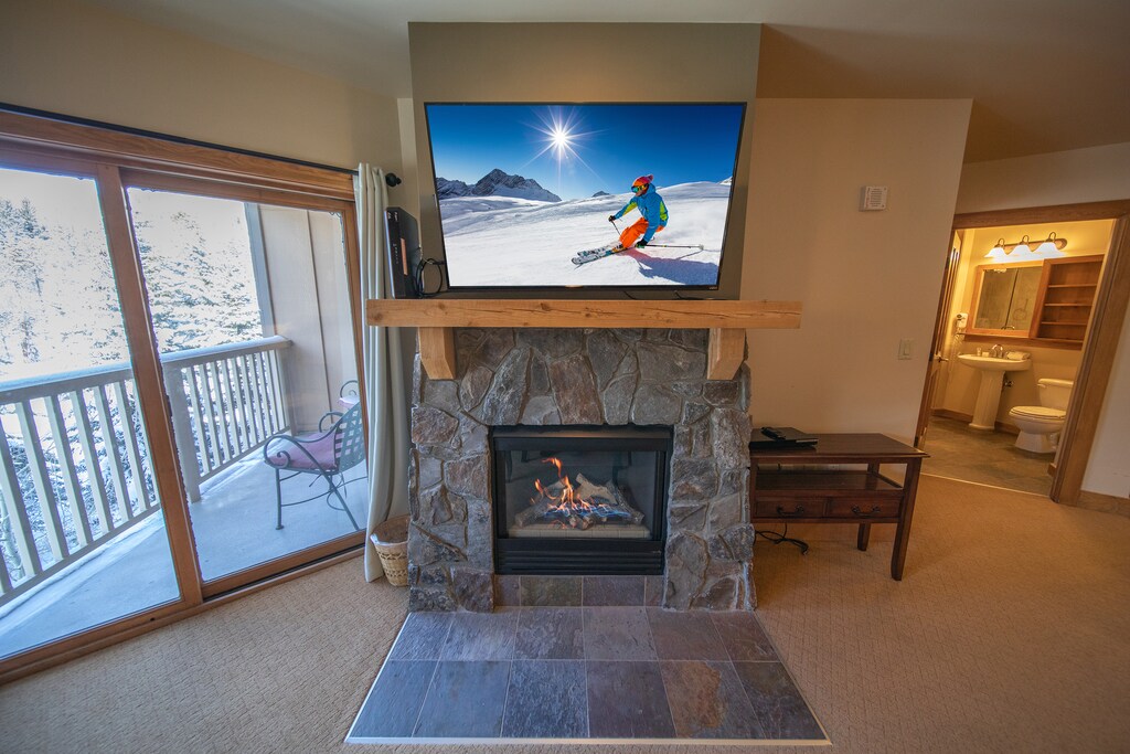 Stone fireplace and large TV