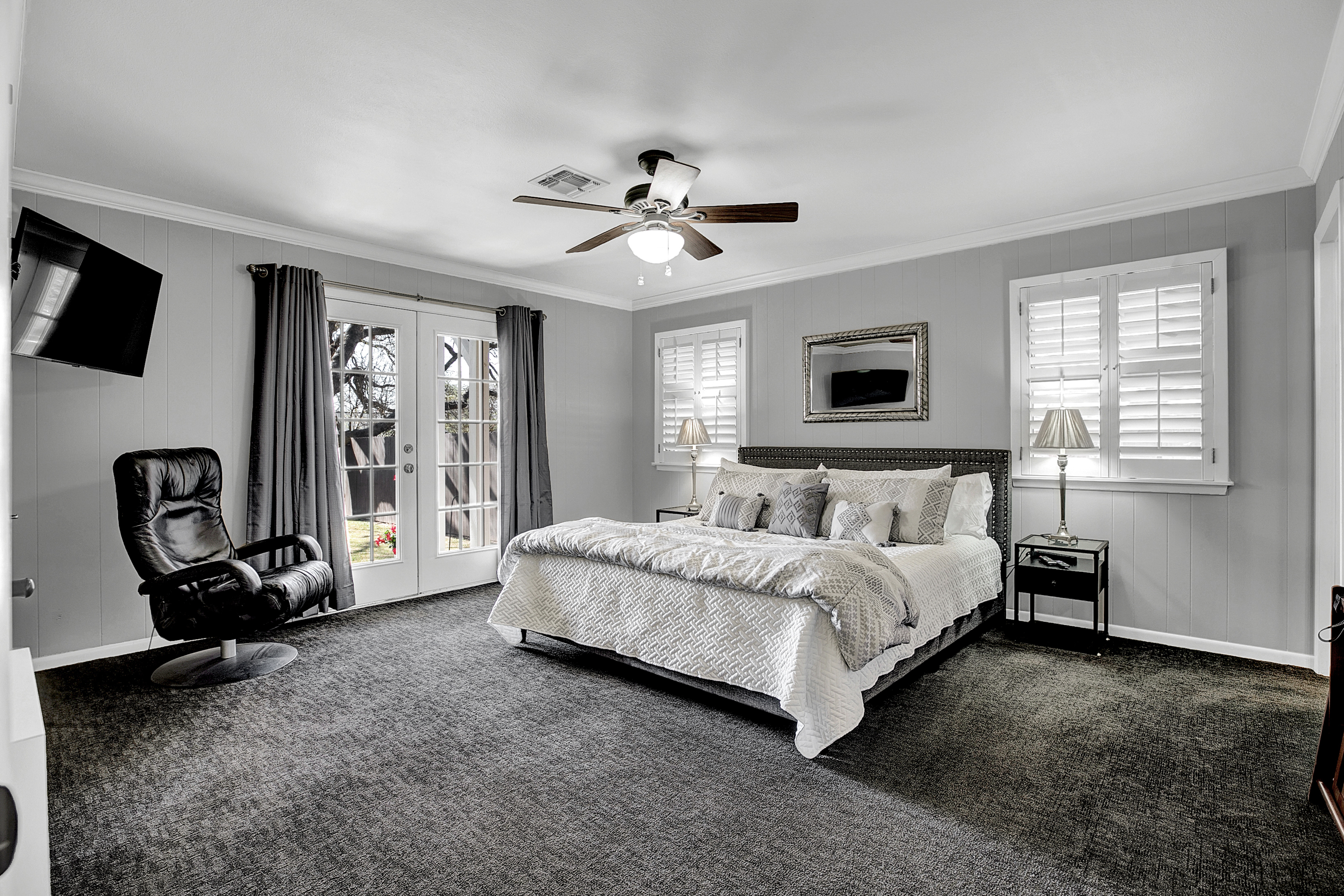 Relax and unwind in style in this stunning master bedroom with a king-sized bed and en suite bathroom.  Step into your own private oasis with French doors leading to a serene backyard retreat.