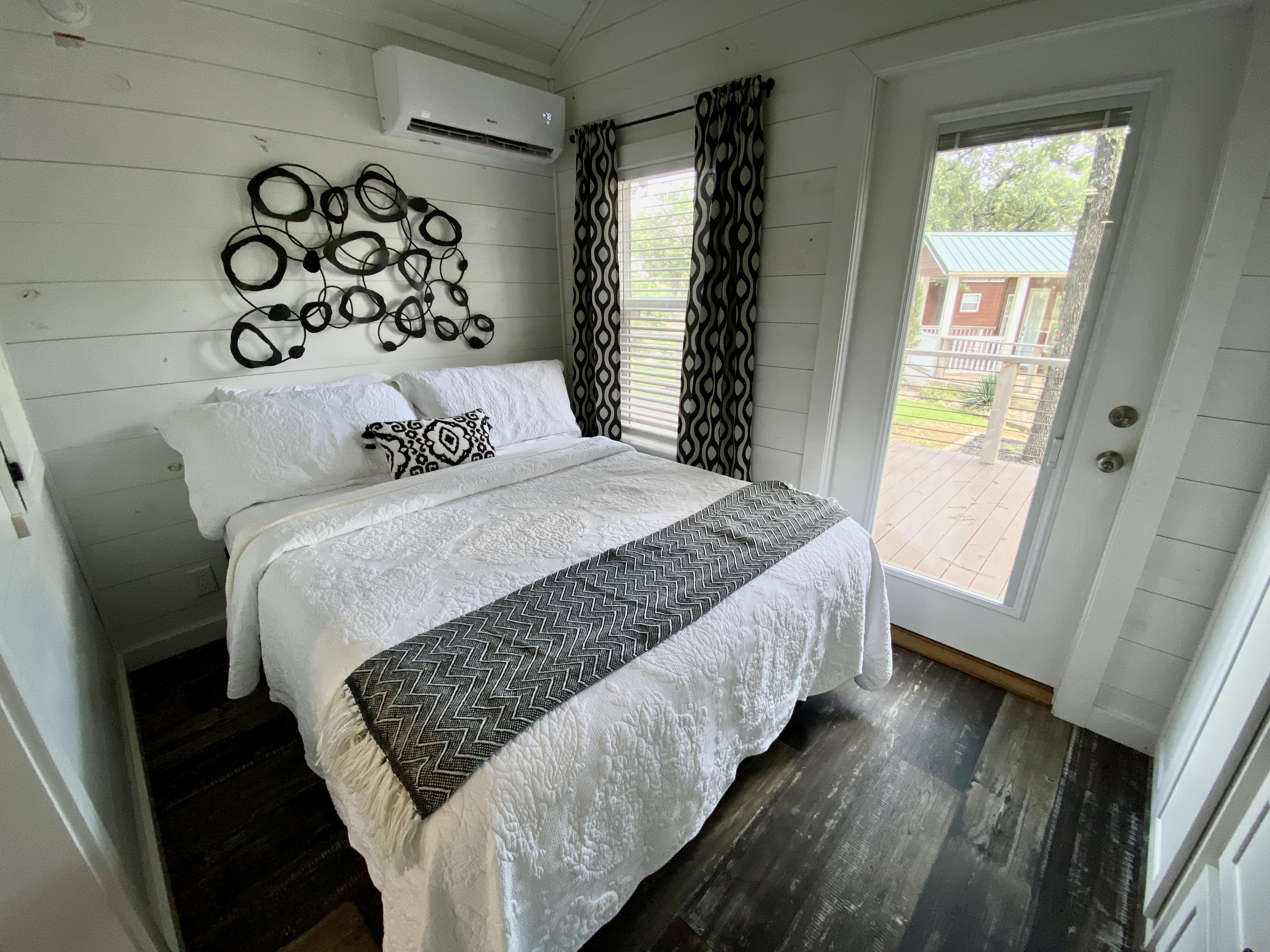 Comfy queen bed for a peaceful night's sleep after a long day of exploring the riverfront property, enjoying our tasting room, and indulging in our exceptional food!