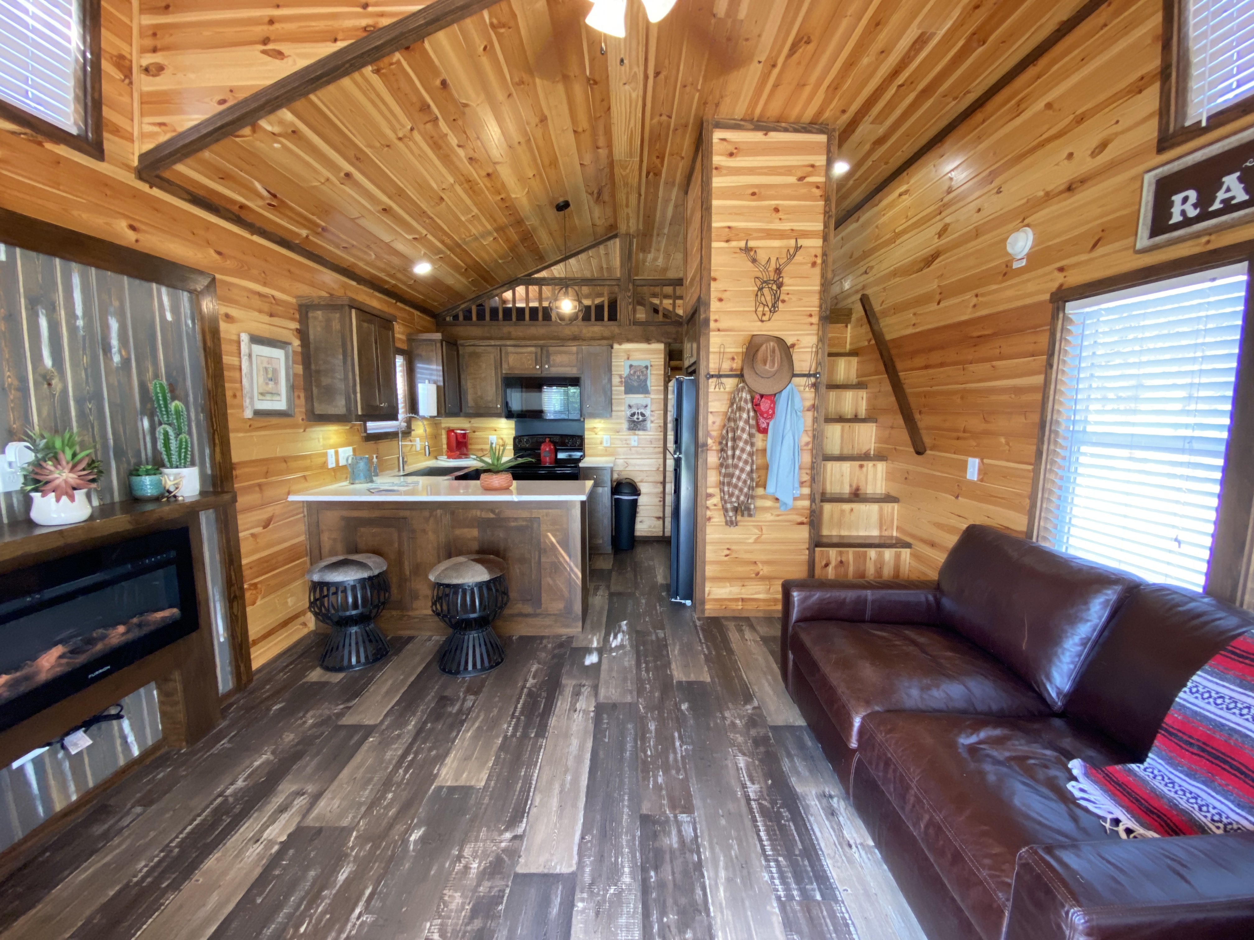 This tiny home exudes a charming Western ambiance with its rustic decor and cowboy-inspired details.
