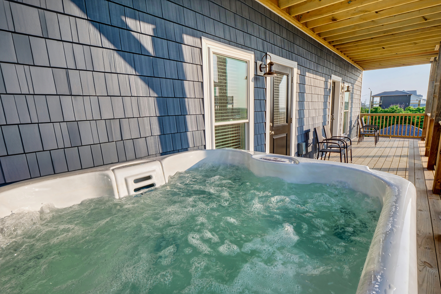 Private hot tub off of full bedroom with views of the sound