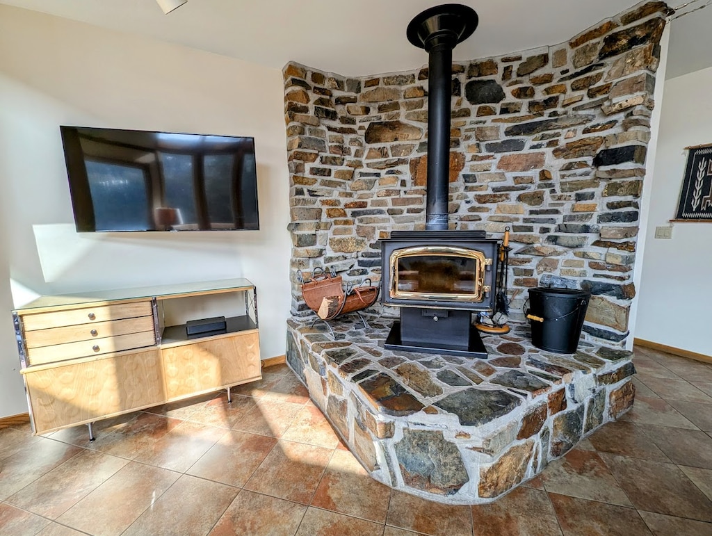 Large flatscreen and wood burning fireplace