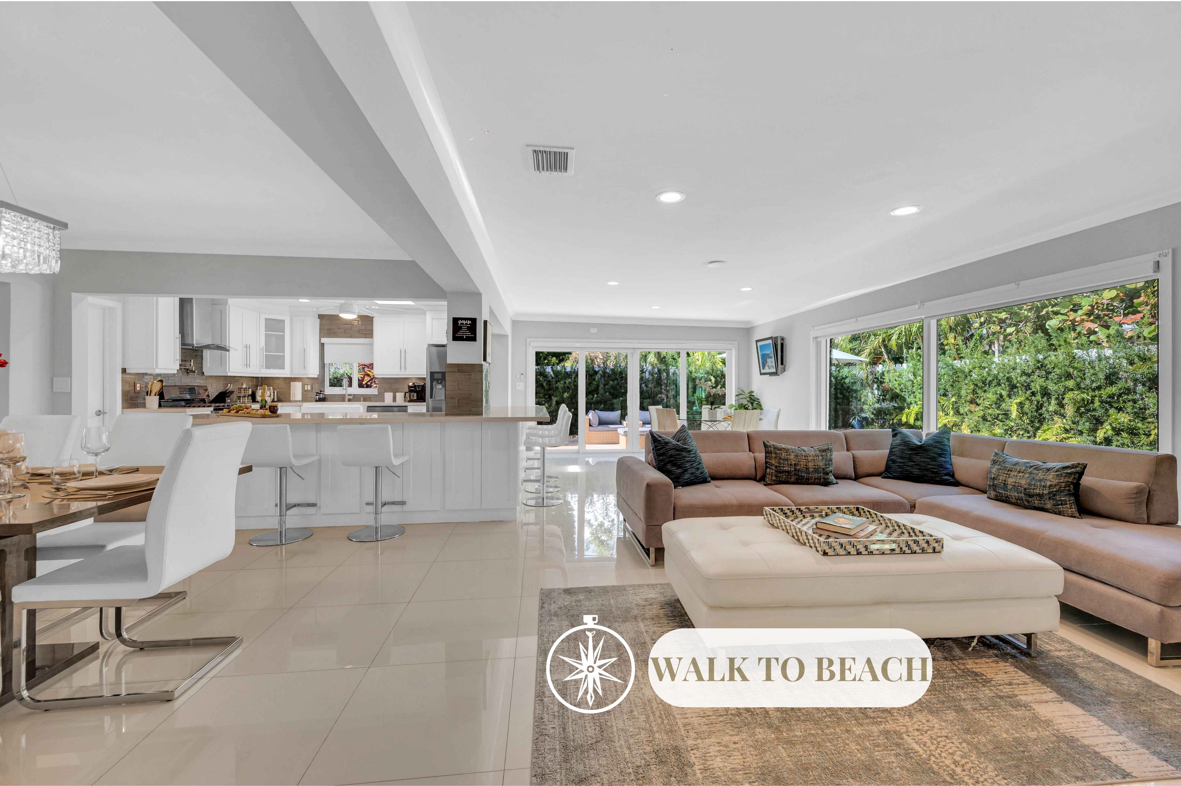 This modern coastal ranch style residence is ideal for tranquil relaxation and privacy with its lush garden and heated pool.