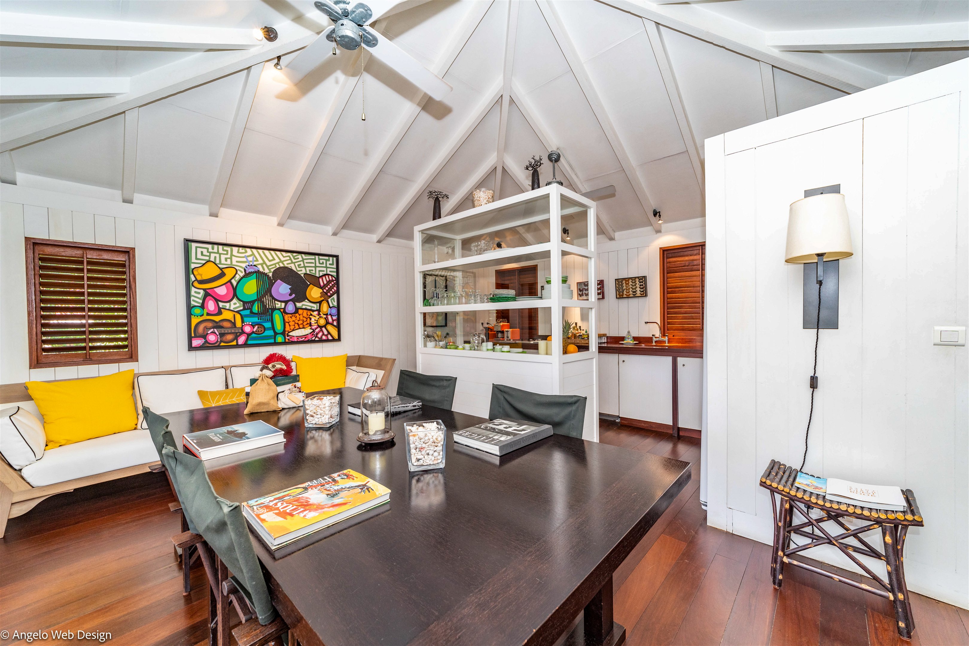 Ceiling fans, large dining table, lounge area. 