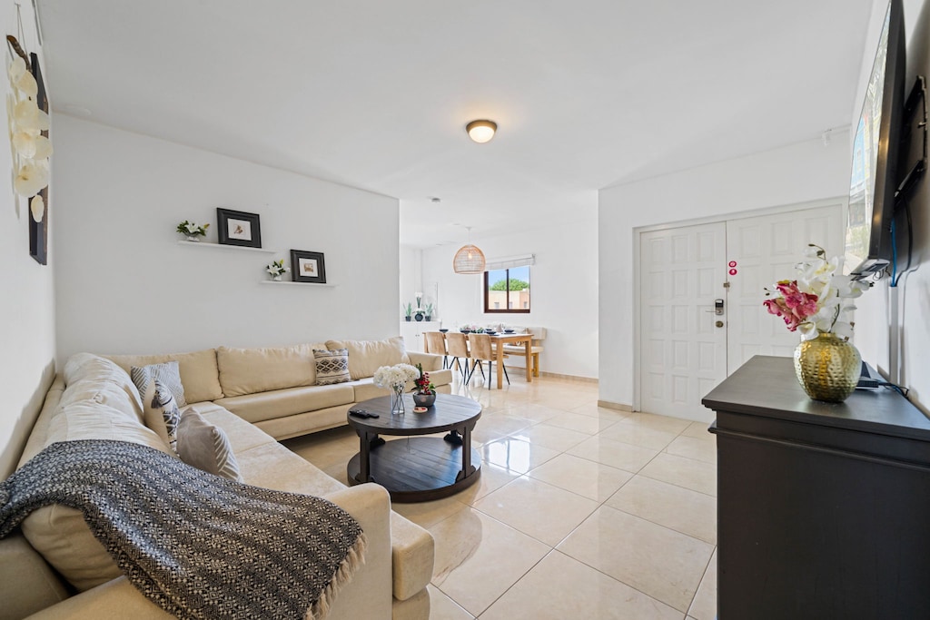 Experience cozy living with a wall-mounted flat screen TV, seamlessly integrated into the living room design.