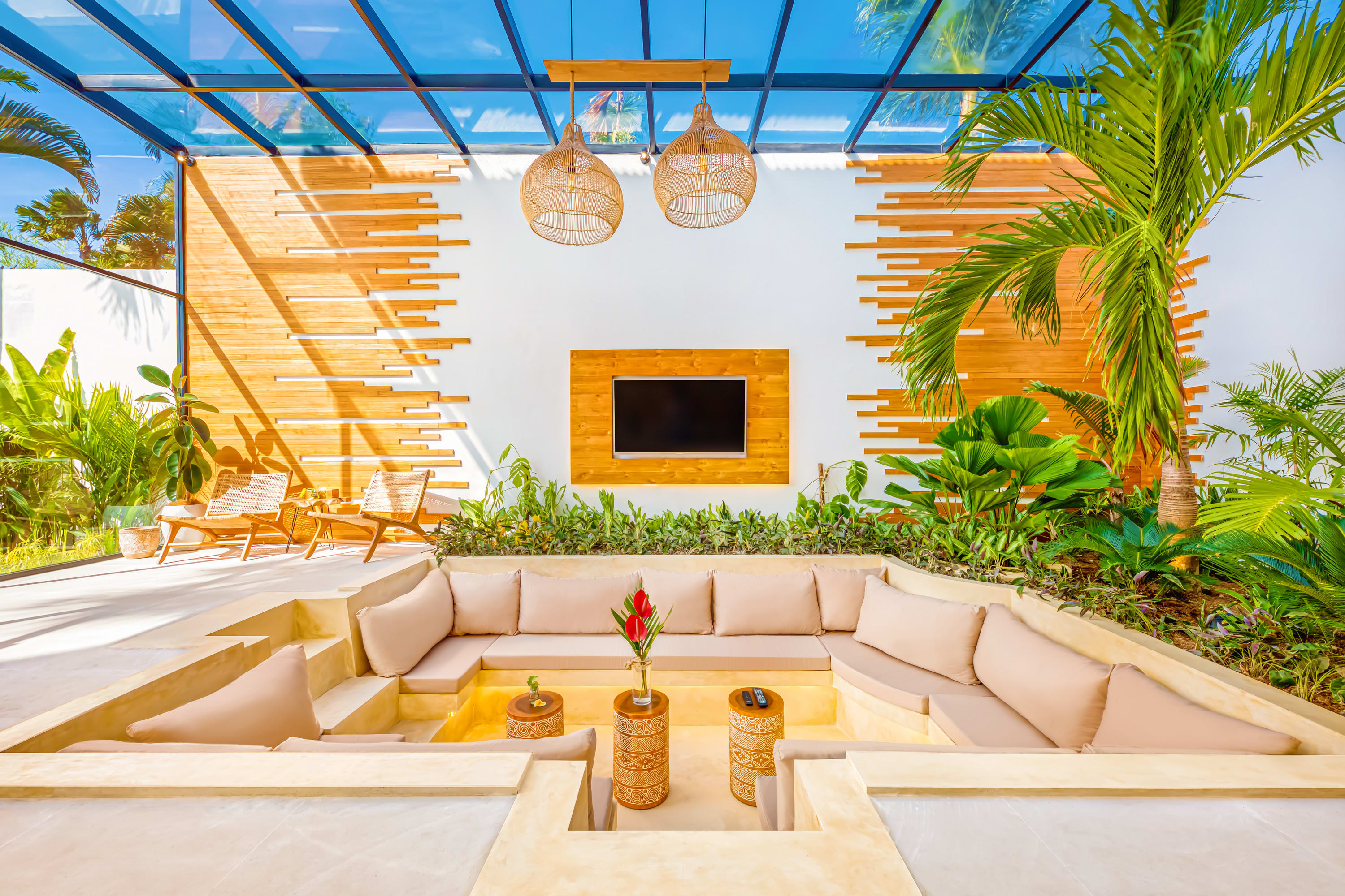A large sunken lounge with indoor garden
