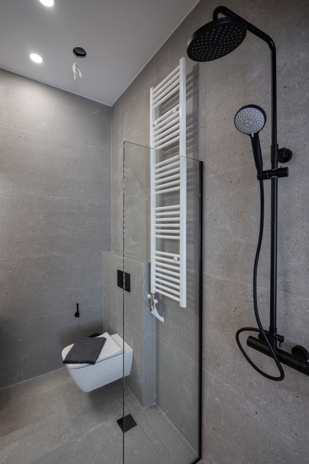 The rain shower is just one of the perks of this beautifully designed bathroom.