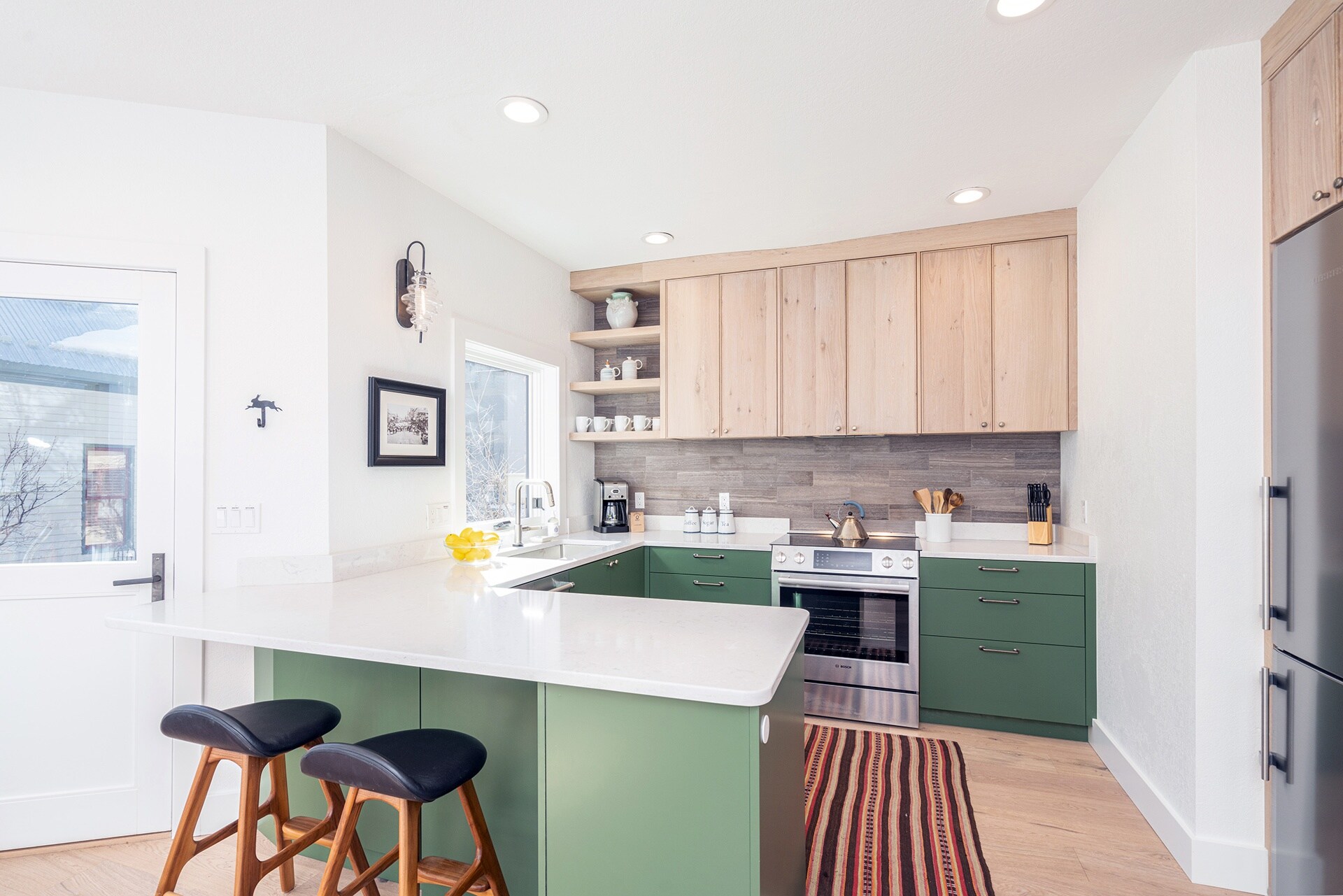 The kitchen is complete with new cabinetry, updated appliances, and a breakfast bar!