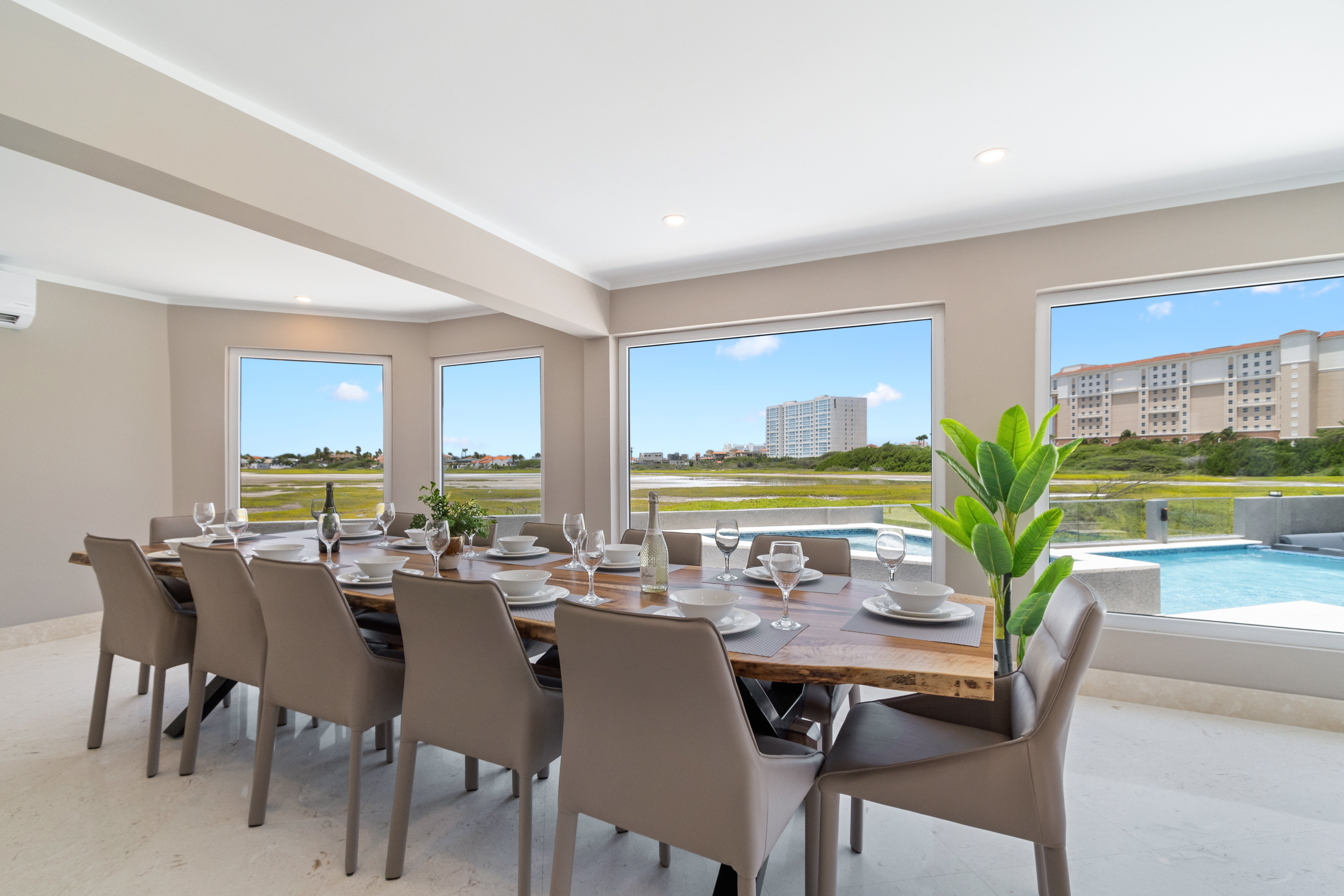 Magnificent Dining Area of the Villa in Noord Aruba  - 12 Persons dining - Stunning outside views - Cohesive design aesthetic carried through from furniture to window treatments - Experience breathtaking views via windows, welcoming natural light